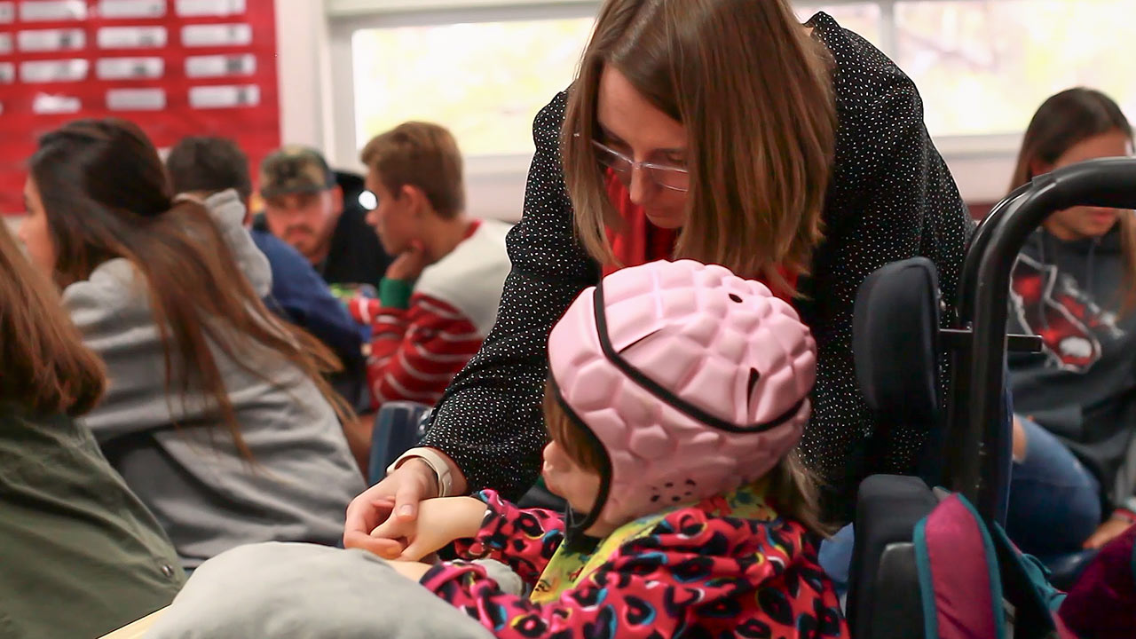 Teacher and girl with pink helmet