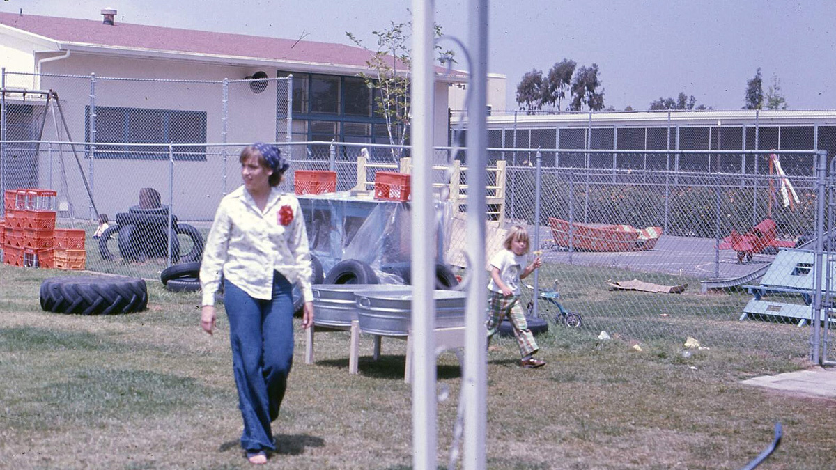 An instructor and child, likely outside the Family Studies and Consumer Sciences building, circa 1970.