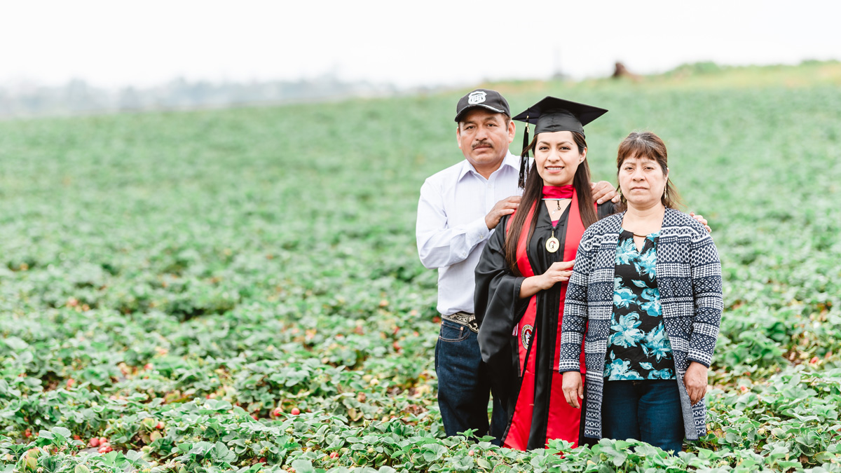 The viral photograph of Erica and her parents in a strawberry field