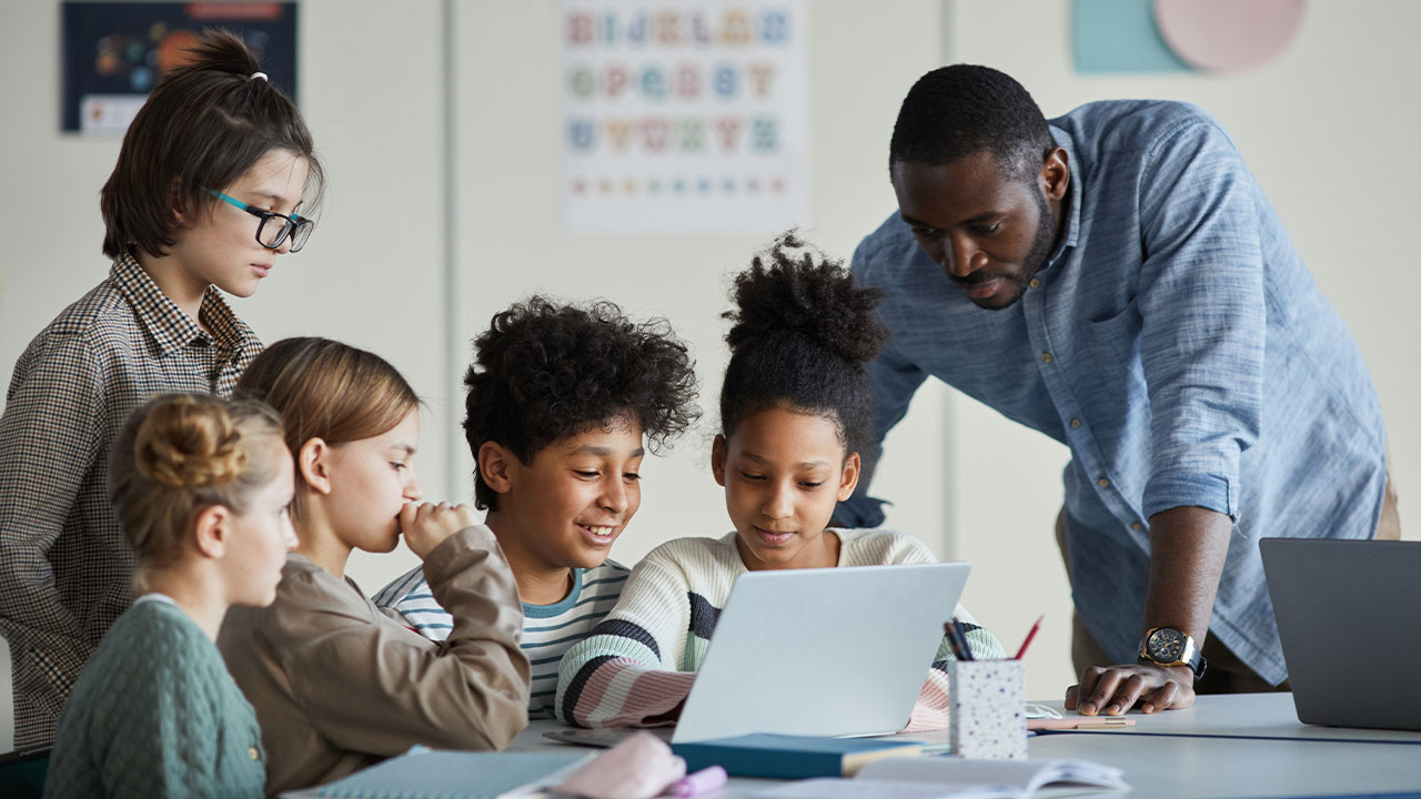 teacher working with students