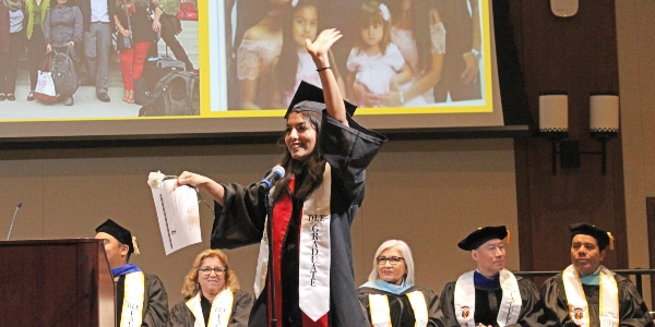 A DLE graduate celebrates at the department's 2019 graduation ceremony.