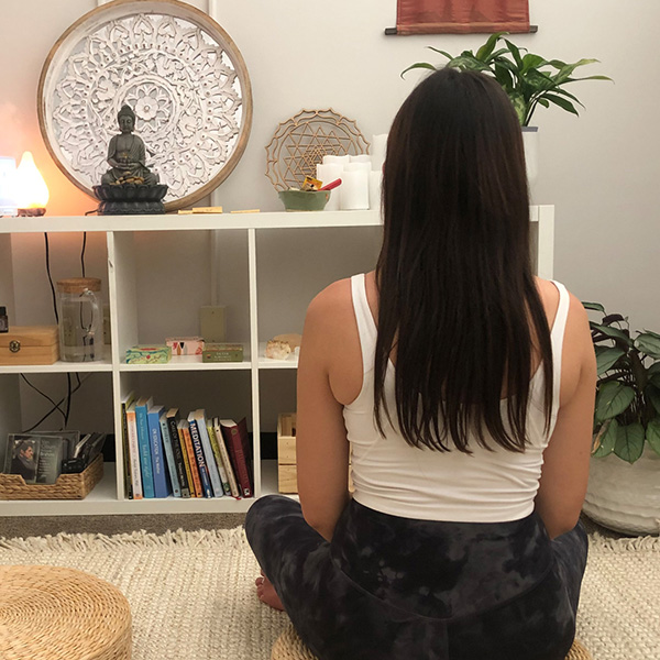 A student meditates in the Self-Care Sanctuario