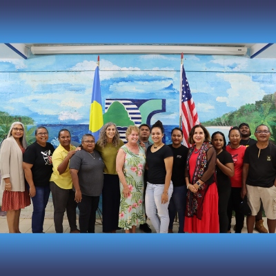 President Adela de la Torre with alumni in Palau