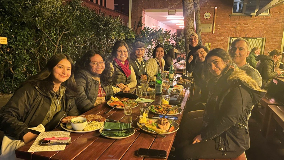 Griselda Paredes (third from left) and Efraín Chávez (far right) enjoy dinner in Berlin with their SDSU team.