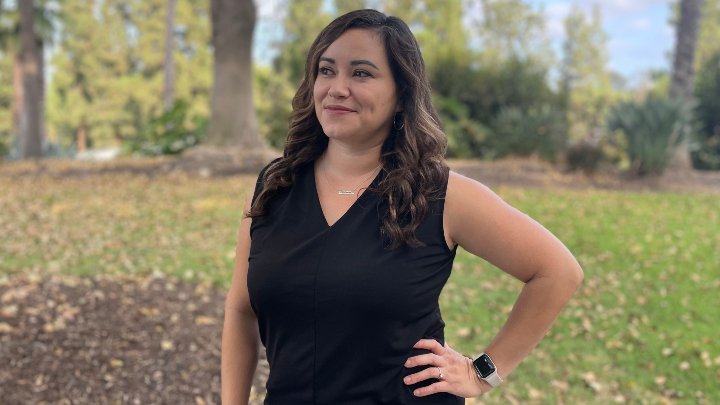 Dr. Marissa Vasquez in front of greenery on the SDSU campus.