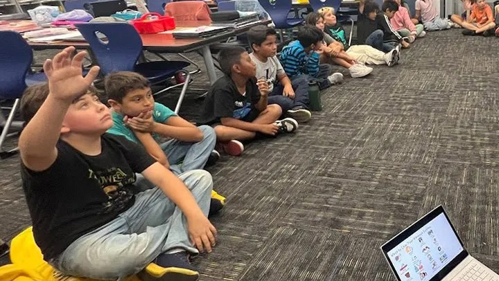 middle school kids sitting on the floor