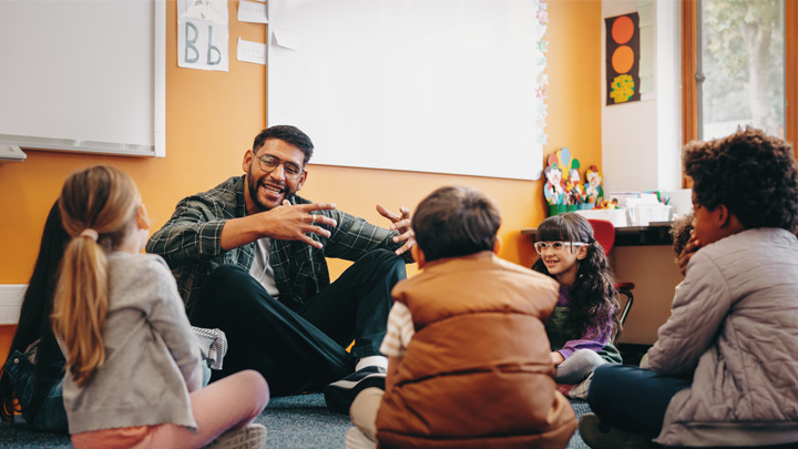 special education teacher sitting with students in a circle